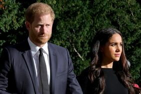 Prince Harry, Duke of Sussex, and Meghan, Duchess of Sussex on the long Walk at Windsor Castle arrive to view flowers and tributes to HM Queen Elizabeth