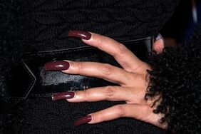 A woman with dark winter nails.