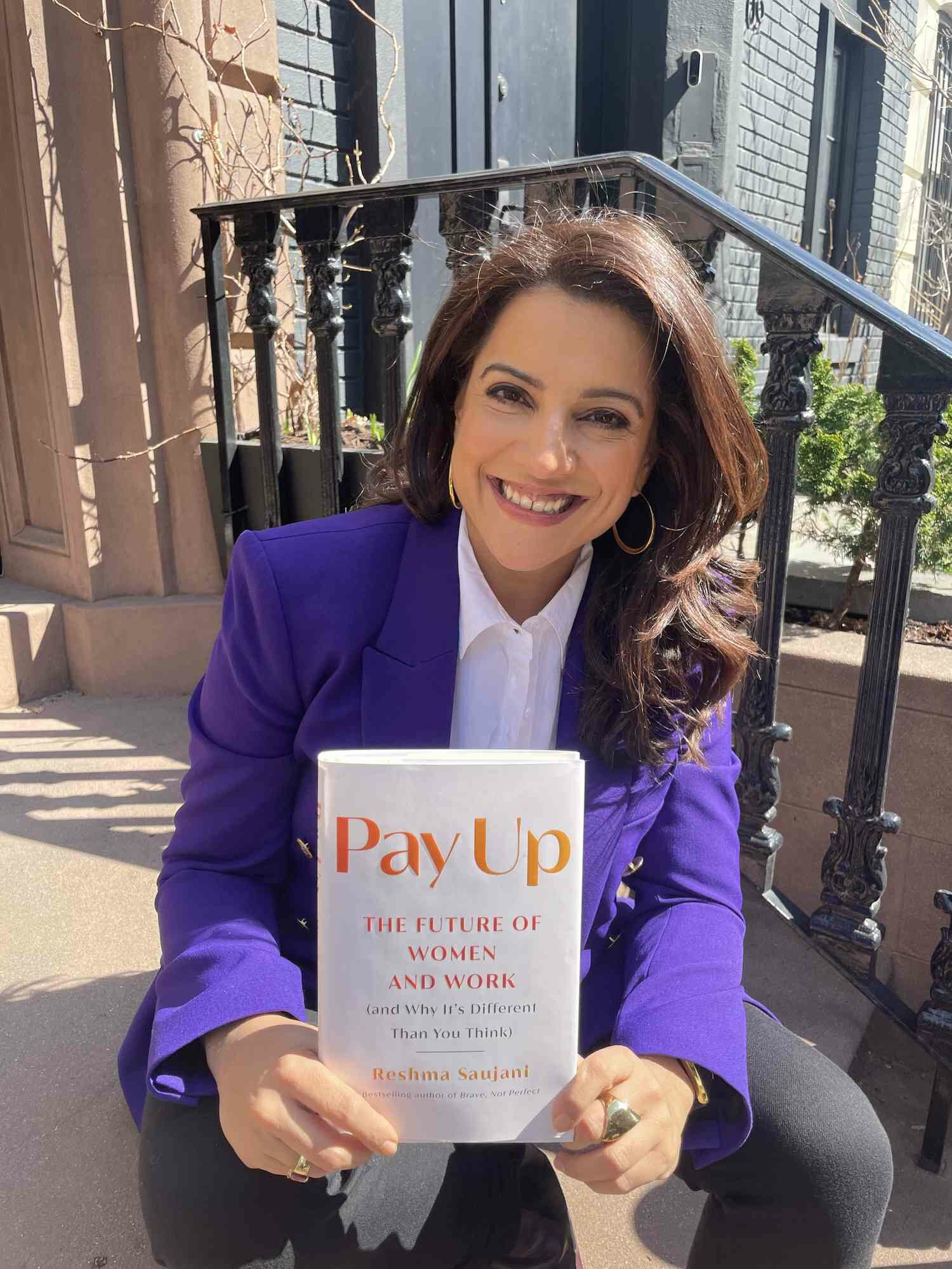 Reshma Saujani with one of her books, Pay Up
