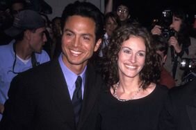 Julia Roberts and Benjamin Bratt smiling together at an event as a couple