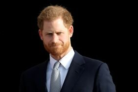 Prince Harry Red Hair and Beard Looking Serious While Squinting and Wearing Suit and Tie