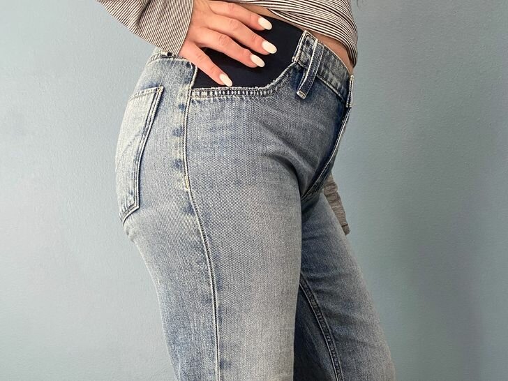 A pregnant person wearing the Hudson Rosie Maternity Wide Leg Ankle Jean