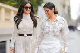Two women wear city hall wedding dress ideas. 
