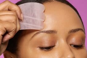 Person using gua sha on their forehead