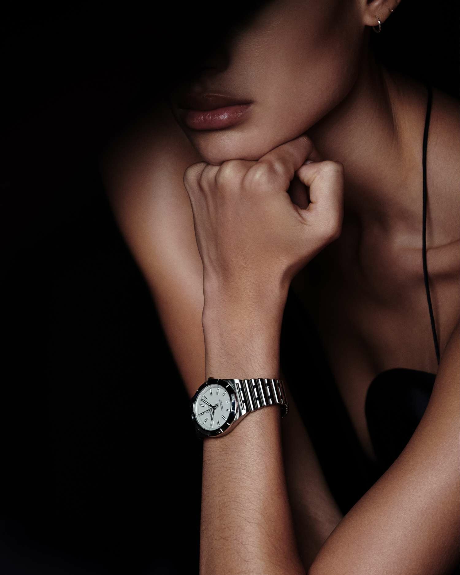 A model wears a watch from the new Breitling x Victoria Beckham campaign.