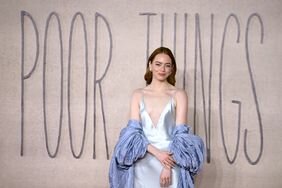 Emma Stone Hand on Wrist Silver Silk Dress Lilac Duster 'Poor Things' London Screening
