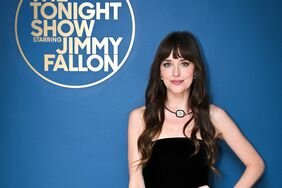 Dakota Johnson Hand on Hip Black Dress Blue Wall 'The Tonight Show Starring Jimmy Fallon'