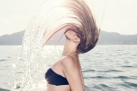 Woman - hair flip - ocean