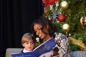 First lady Michelle Obama sits with Stephen Orzechowski, 5, center, and Santa Claus as she reads "Twas the Night Before Christmas" to a group of children at the Children’s National Health System in Washington, Monday, Dec. 14, 2015.