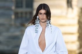 Kaia Gerber, wearing a haute couture fashion week trend you can actually wear, walks the Valentino runway at Haute Couture fashion week.
