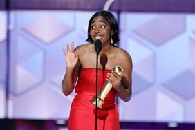 Ayo Edebiri giving her acceptance speech at the 2024 Golden Globes wearing a red dress