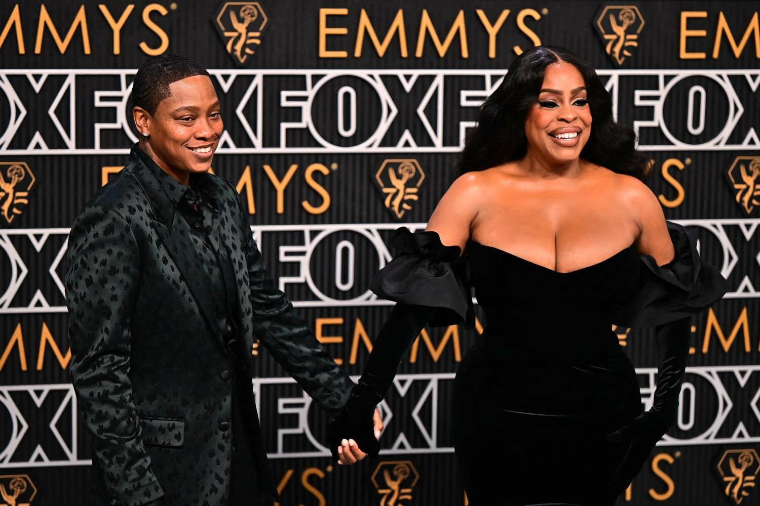 Niecy Nash and her wife singer Jessica Betts holding hands on the Emmys red carept