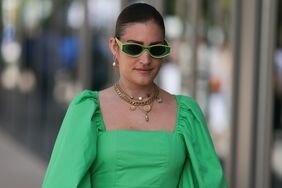 Person wearing a green blouse/dress and sunglasses