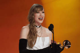 Taylor Swift holding grammy 2024