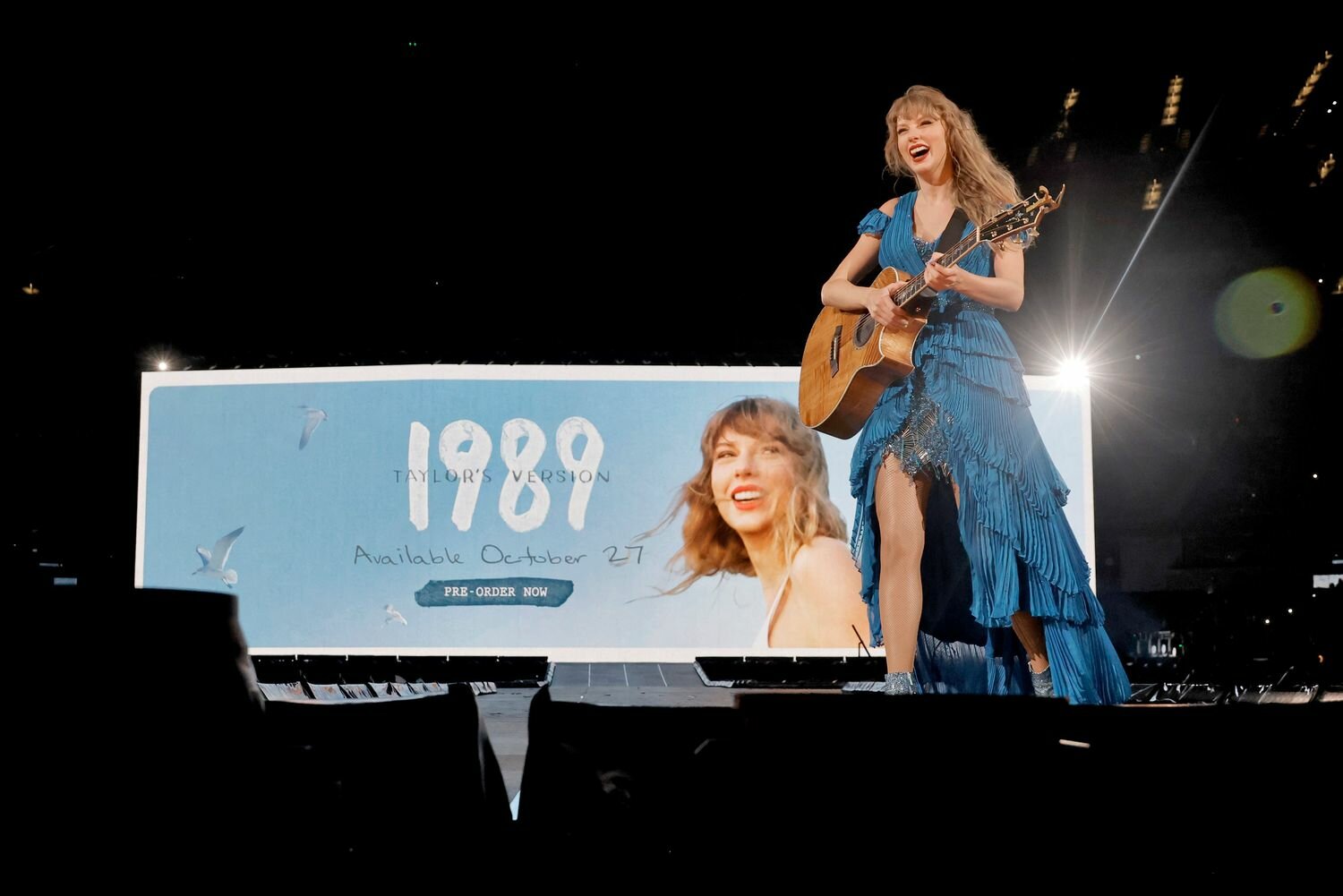 Taylor Swift performs onstage during "Taylor Swift | The Eras Tour" in a blue dress