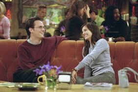 Chandler Bing and Monica Geller Smiling Sitting on Famous 'Friends' Couch Season 7, Episode 4 "The One With Rachel's Assistant"