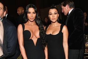 Kim and Kourtney Kardashian Posing Straight Faces Black Dresses
