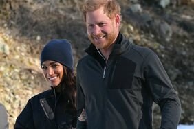 Meghan Markle Holding Prince Harry's Arm While Both Smiling and Walking Through the Snow at Invictus Event in Canada