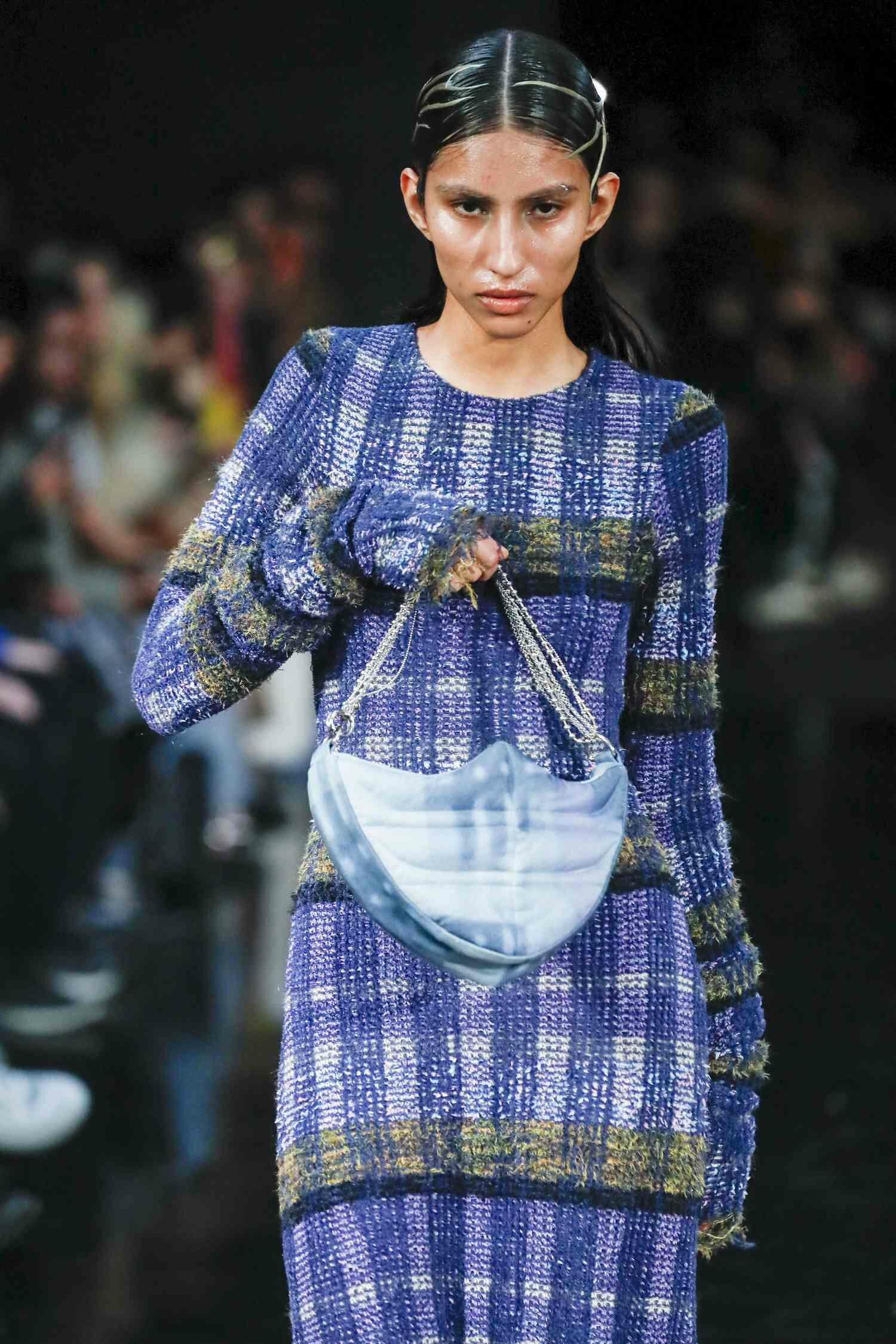 A Collina Strada model holds a top handle bag, NYFW Fall 2024's best bag trend.