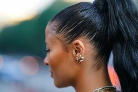 Person with natural hair styled in a high slicked-back ponytail
