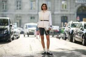 A woman wears bike shorts and a puffer vest