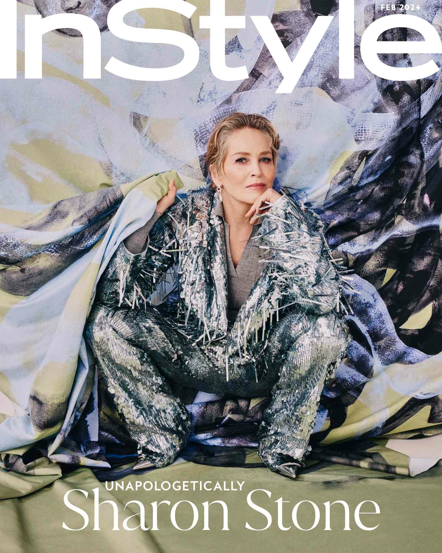 Sharon Stone InStyle February Cover crotching in front of green purple and black painting wearing a silver frayed suit
