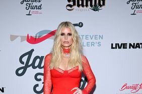Jessica Simpson Red Dress Hand on Hip 2024 Grammys Viewing Party