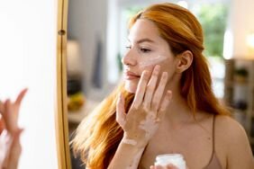 Woman applying moisturizer with peptides in it