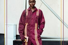 Person wearing a burgundy jumpsuit with yellow stripes