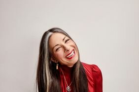 Stacy London sitting and smiling