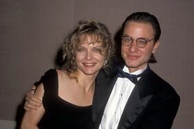 Michelle Pfeiffer and Fisher Stevens in formalwear posing together