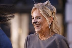 U.S. first lady Jill Biden wears cat ears and makeup while handing out books during a Halloween trick-or-treat event