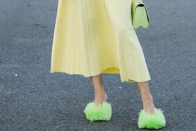 Woman in yellow pleated skirt