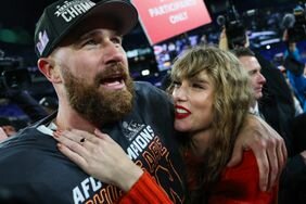 Taylor Swift Red Lip Red Sweater Smiling Up at Travis Kelce Hand On His Chest After Kansas City Chiefs Win Against Baltimore Ravens in AFC Championship