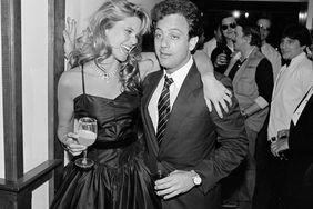 Christie Brinkley and Billy Joel at a party holding drinks