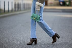 A woman wearing ankle boots and jeans