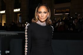 Jennifer Lopez Straight Face Posing in Hair Bow Black Dress Bedazzled Cutouts Valentino 2024 Spring-Summer
