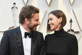 Bradley Cooper and Irina Shayk Looking At Each Other Smiling Holding Hands Red Carpet 2019 Oscars
