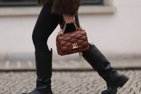 A woman wears a boots and leggings outfit 