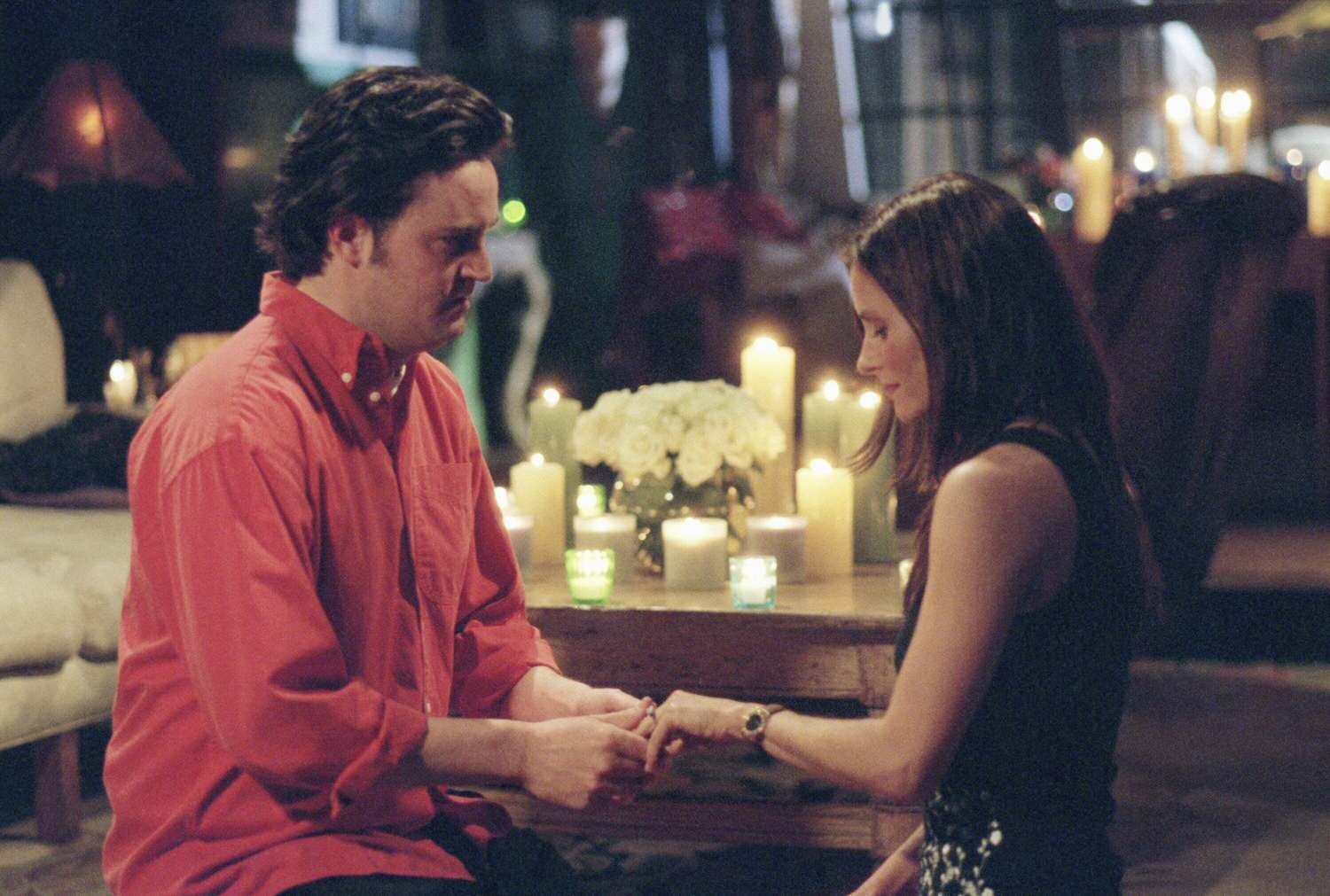 Monica Geller and Chandler Bing Kneeling Holding Hands Engagement Episode