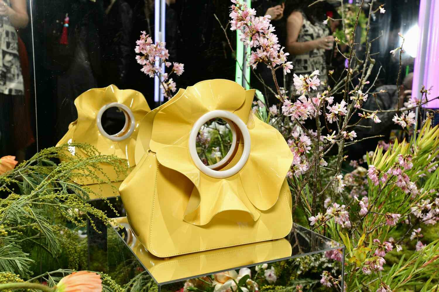 The Flora Patent Leather 3D Flower Top Handle Bag from the Kate Spade Time to Bloom collection