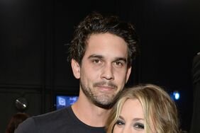 Kaley Cuoco and Ryan Sweeting smiling and posing together