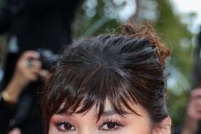 Gemma Chan with a choppy bangs and updo