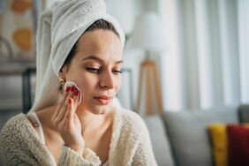 Woman using product with witch hazel for acne 