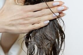 Detail of person washing their hair extensions