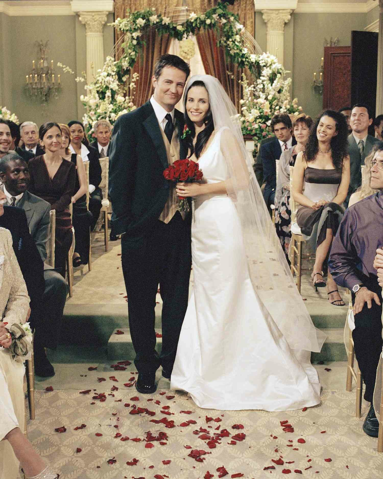 Chandler Bing and Monica Geller in Wedding Attire Posing in Aisle at Their Wedding "The One With Monica And Chandler's Wedding" Season 7, Episode 23