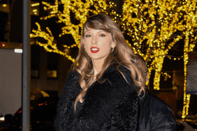 Taylor Swift wearing red lipstick and black coat during the holidays