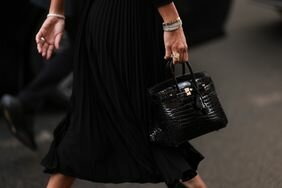 A woman wearing a black long dress