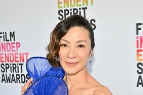 Michelle Yeoh wearing a blue gown with giant ruffle details
