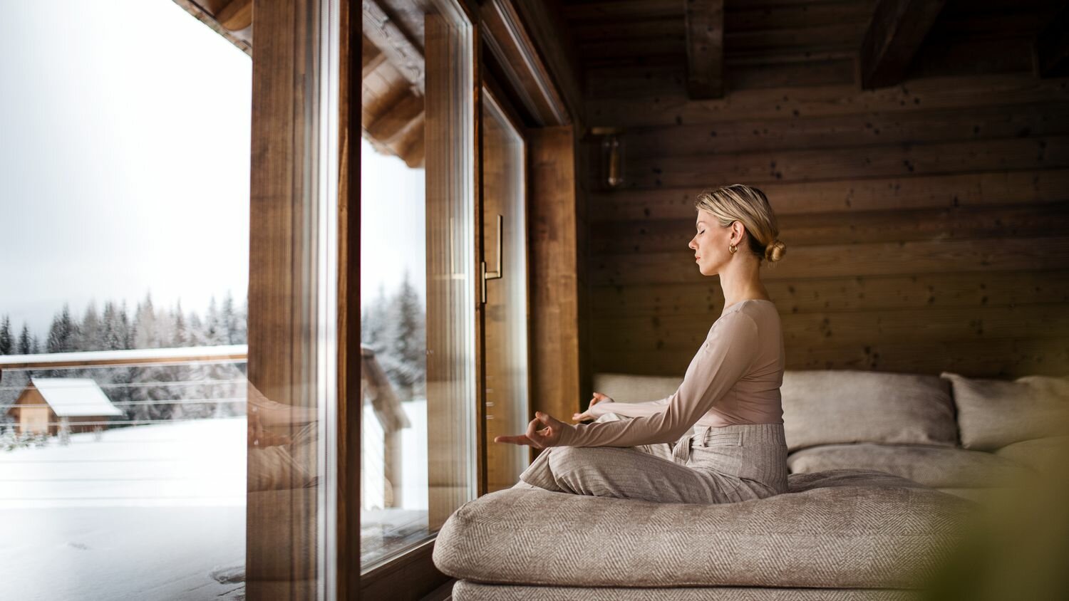 Woman meditating in front of a window